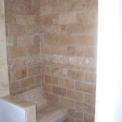 Chisled travertine with bench shower